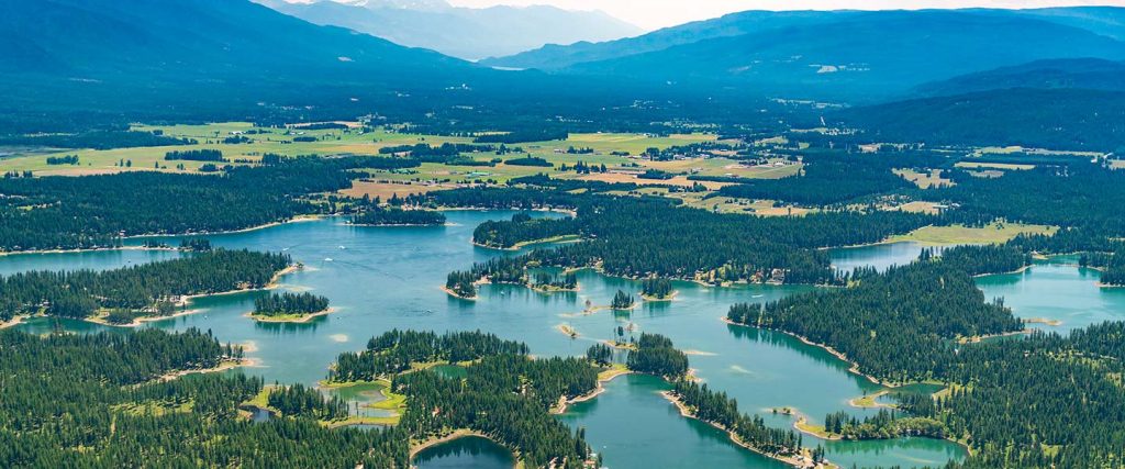 Aerial view of lakes with surrounding mountains.